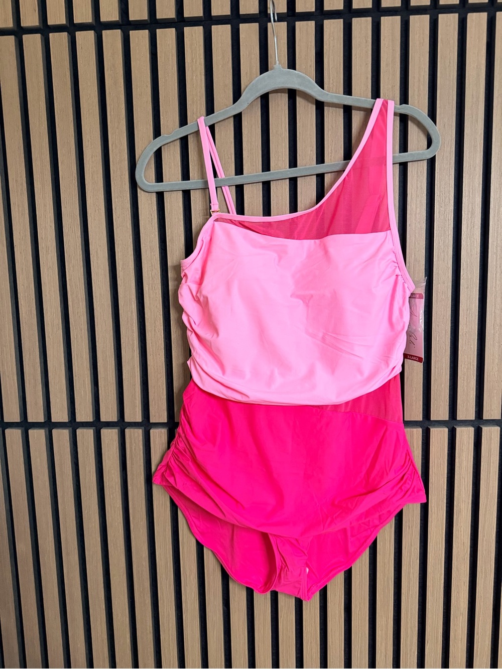 Anne Cole Gold Script Logo Tag with Pink Swimsuit Peek